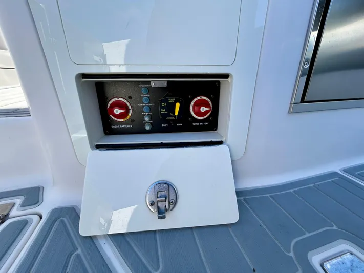 All Gas No Brakes Yacht Photos Pics Control panel on 2020 Regal 33 SAV boat with red switches and gray flooring.