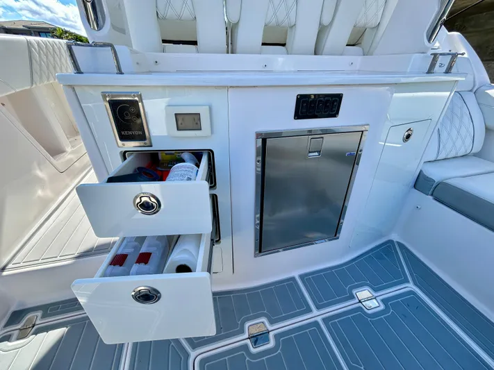 All Gas No Brakes Yacht Photos Pics 2020 Regal 33 SAV boat interior with storage drawers and mini fridge.