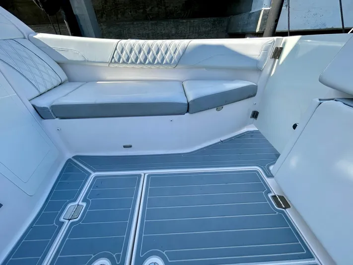 All Gas No Brakes Yacht Photos Pics 2020 Regal 33 SAV boat interior with cushioned seating and sleek flooring.