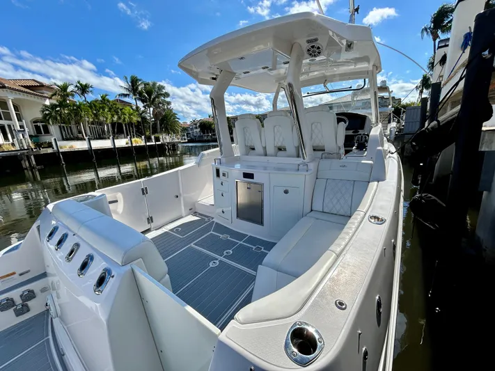 All Gas No Brakes Yacht Photos Pics 2020 Regal 33 SAV boat with spacious deck and seating, docked by waterfront homes.