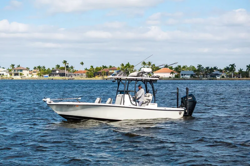  Yacht Photos Pics 2021 Barker Boatworks 26 Open cruising on a sunny day near waterfront homes.