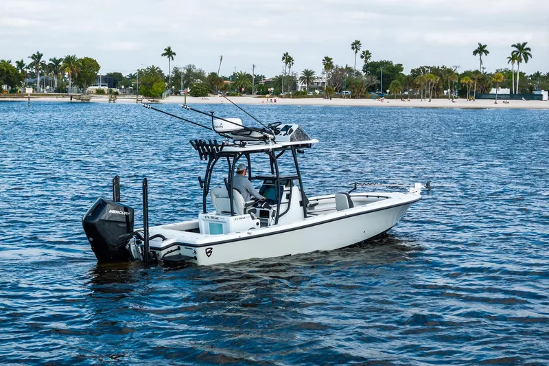  Yacht Photos Pics 2021 Barker Boatworks 26 Open on water, equipped with fishing gear, near a tropical shoreline.