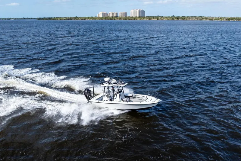  Yacht Photos Pics 2021 Barker Boatworks 26 Open cruising on open water, distant shoreline visible.