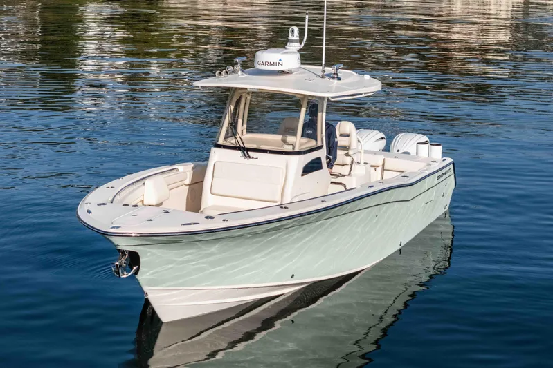  Yacht Photos Pics 2022 Grady-White Canyon 306 boat on calm water, featuring sleek design and modern equipment.