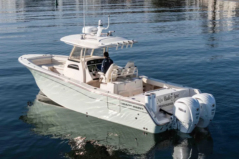  Yacht Photos Pics 2022 Grady-White Canyon 306 boat on calm water, featuring dual Yamaha engines.