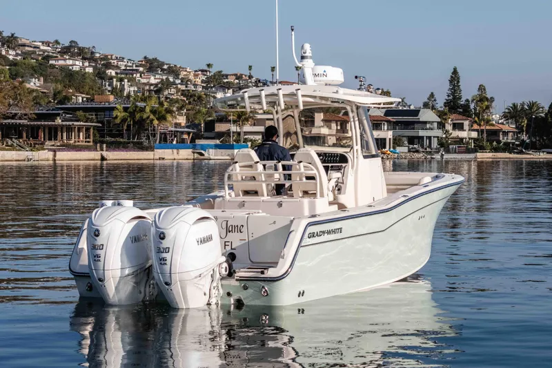  Yacht Photos Pics 2022 Grady-White Canyon 306 boat with twin Yamaha engines on calm water.