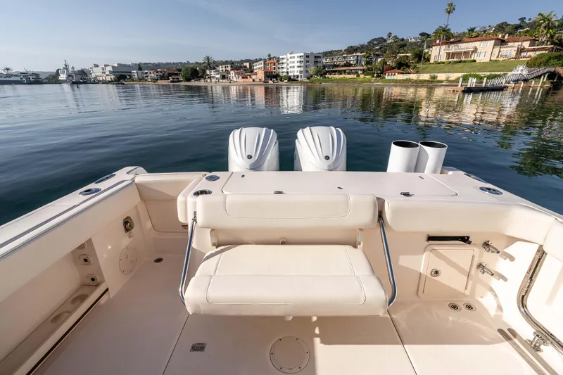  Yacht Photos Pics 2022 Grady-White Canyon 306 boat with dual engines, docked near waterfront homes.