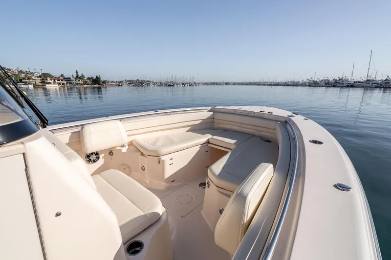  Yacht Photos Pics 2022 Grady-White Canyon 306 boat interior with seating, docked in a calm marina.