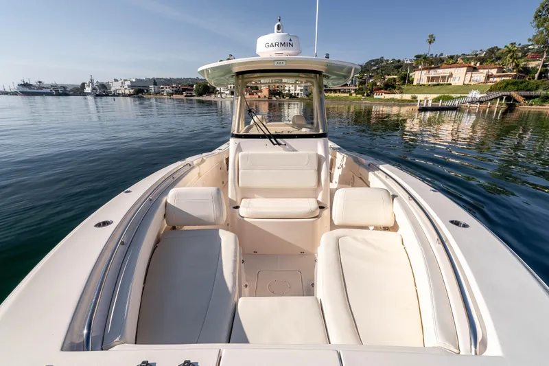  Yacht Photos Pics 2022 Grady-White Canyon 306 boat on calm water, featuring spacious seating and Garmin equipment.