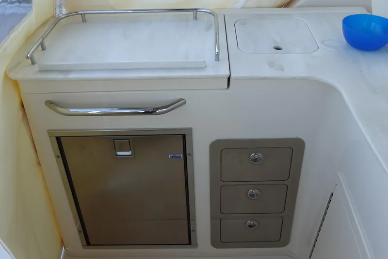  Yacht Photos Pics 2021 Grady-White Freedom 325 boat interior with storage and sink area.