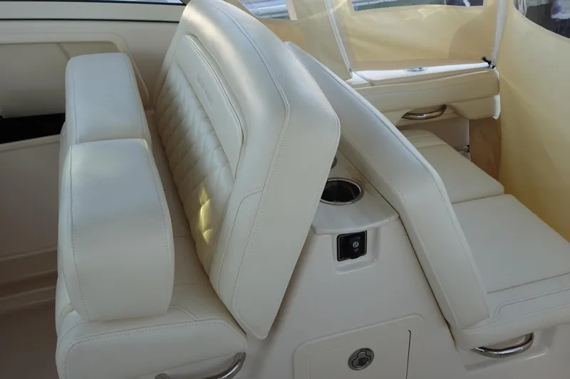  Yacht Photos Pics 2021 Grady-White Freedom 325 boat interior with beige seating and cup holder.