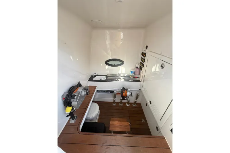Scott Free Yacht Photos Pics 2024 Contender 44 ST boat interior with wooden flooring and fishing equipment.