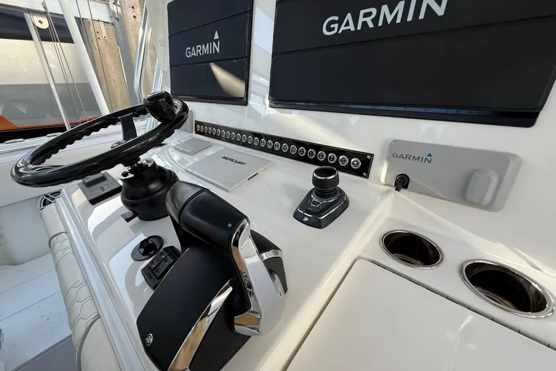 Scott Free Yacht Photos Pics 2024 Contender 44 ST boat dashboard with Garmin navigation system and steering wheel.
