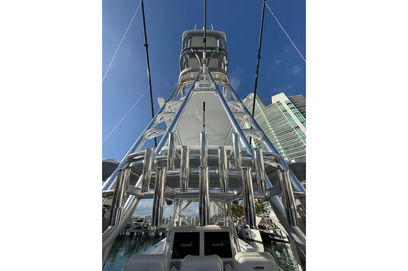 Scott Free Yacht Photos Pics 2024 Contender 44 ST boat tower with clear blue sky and modern buildings.