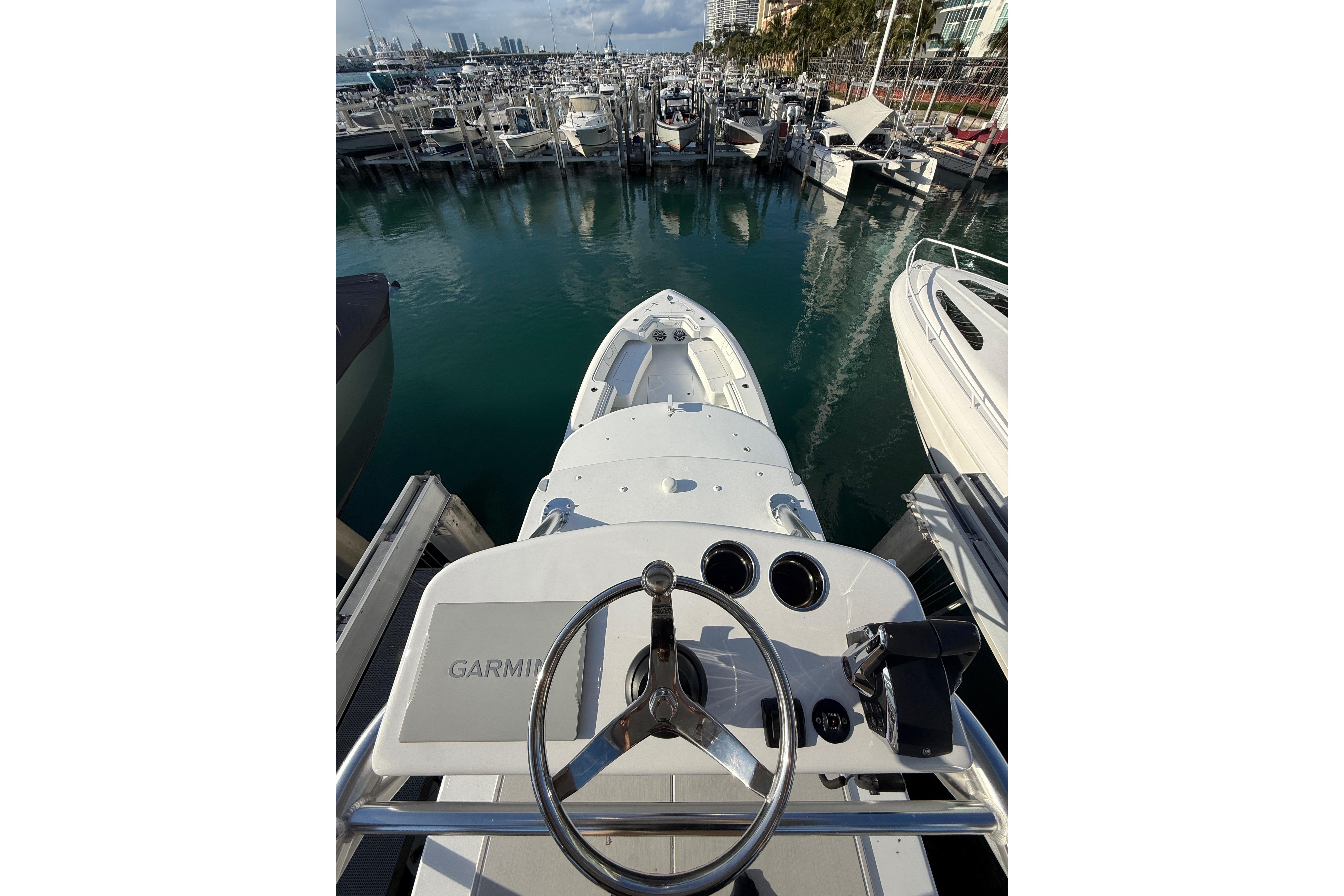 2024 Contender 44 ST boat docked at marina, view from helm with Garmin equipment.