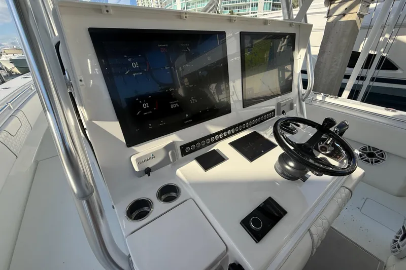 Scott Free Yacht Photos Pics 2024 Contender 44 ST boat dashboard with dual screens and steering wheel.