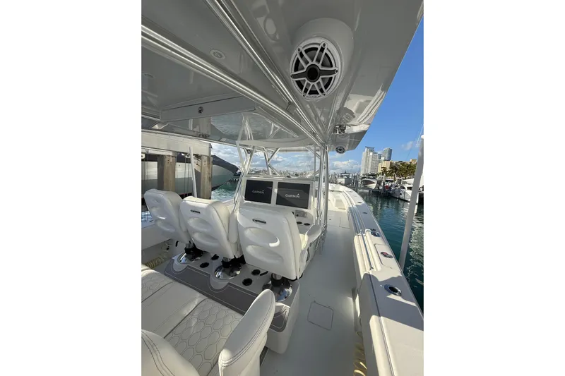 Scott Free Yacht Photos Pics 2024 Contender 44 ST boat interior with modern seating and navigation system at marina.
