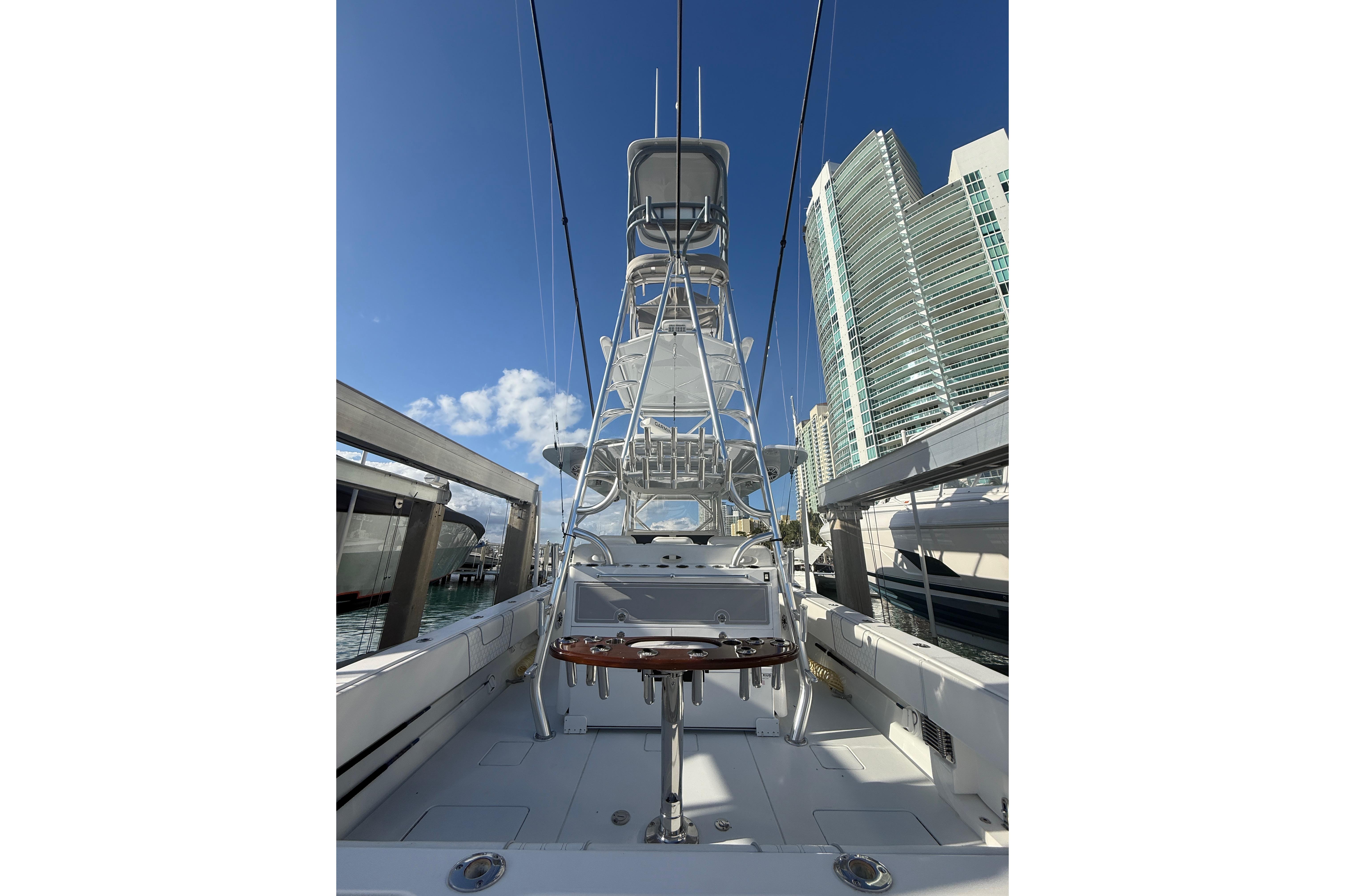 2024 Contender 44 ST boat docked, featuring a tall tower and modern design.