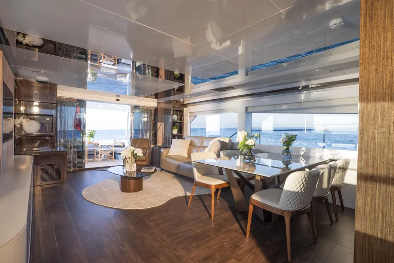 Omnia Yacht Photos Pics Luxurious interior of 2018 Pearl 80 yacht with elegant dining and seating area.
