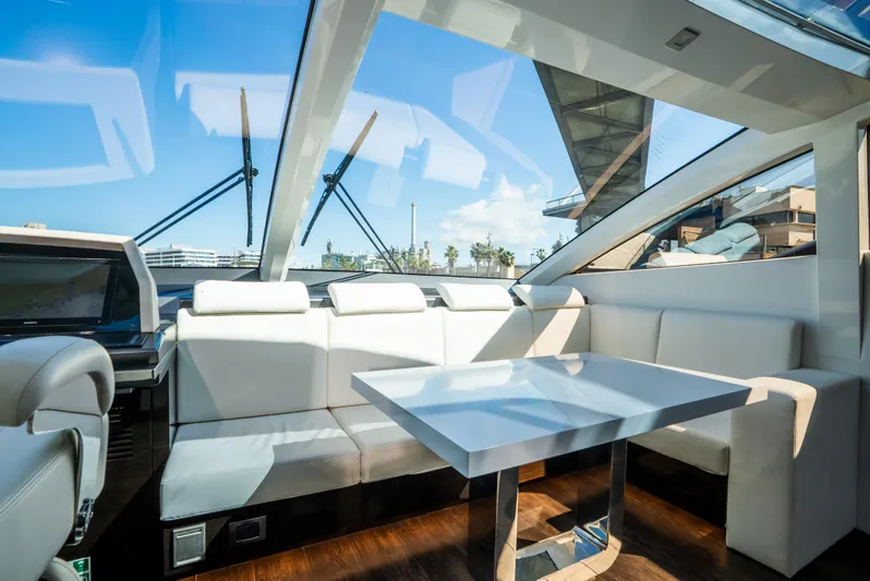 Omnia Yacht Photos Pics Luxurious interior of 2018 Pearl 80 yacht with white seating and sleek table.