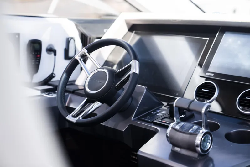 Omnia Yacht Photos Pics Steering wheel and controls of a 2018 Pearl 80 yacht cockpit.