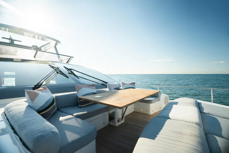 Omnia Yacht Photos Pics Luxurious Pearl 80 yacht deck with seating, ocean view, and clear blue sky, 2018 model.