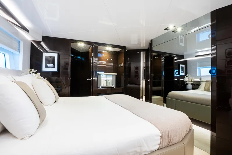 Omnia Yacht Photos Pics Luxurious bedroom interior on a 2018 Pearl 80 yacht, featuring elegant decor and modern design.