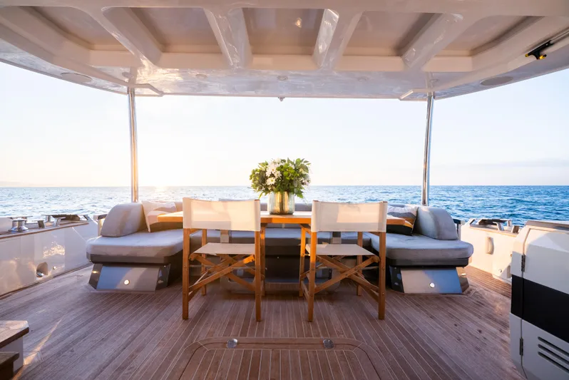 Omnia Yacht Photos Pics Luxurious Pearl 80 yacht deck with seating, ocean view, and sunset ambiance, 2018 model.