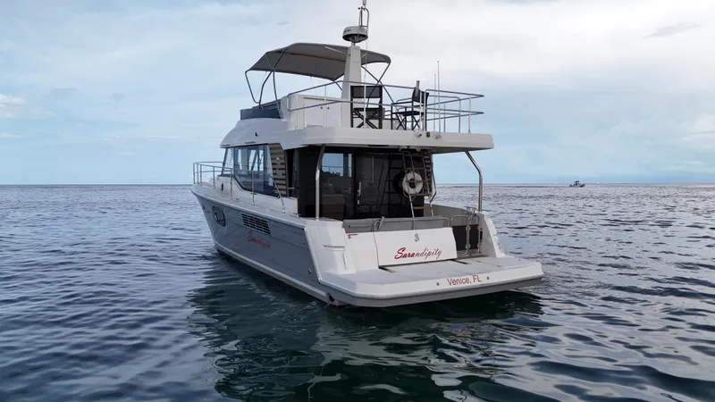 Sarandipity Yacht Photos Pics 2024 Beneteau Swift Trawler 41 Fly on calm ocean waters, rear view.