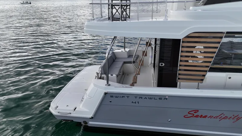 Sarandipity Yacht Photos Pics 2024 Beneteau Swift Trawler 41 Fly on water, showcasing sleek design and spacious deck.