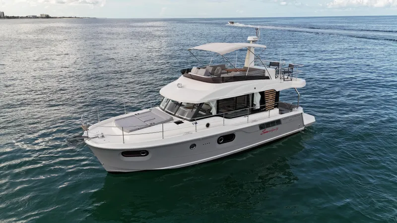 Sarandipity Yacht Photos Pics 2024 Beneteau Swift Trawler 41 Fly cruising on open water, showcasing sleek design and spacious flybridge.