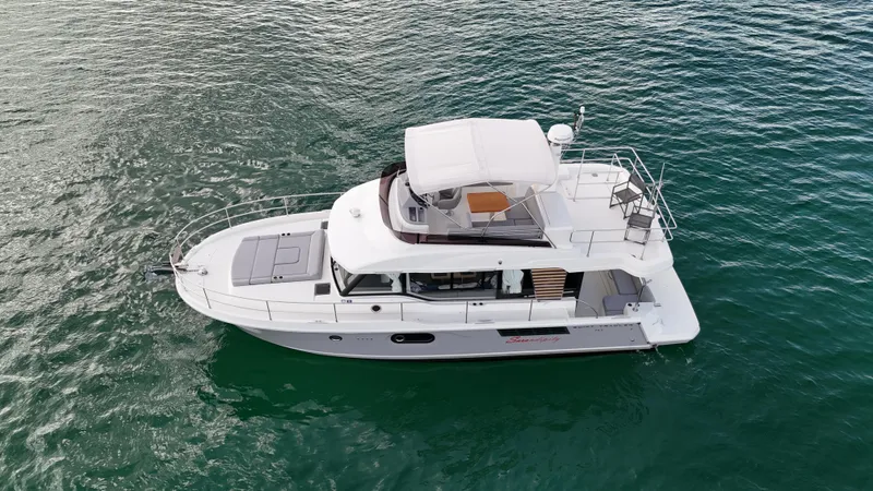 Sarandipity Yacht Photos Pics 2024 Beneteau Swift Trawler 41 Fly cruising on calm waters, aerial view.