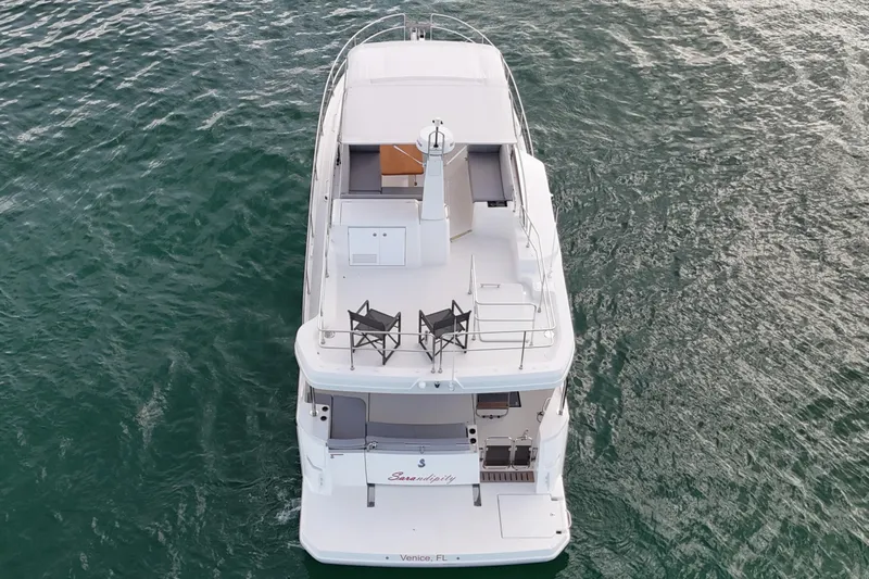 Sarandipity Yacht Photos Pics 2024 Beneteau Swift Trawler 41 Fly cruising on open water, aerial view.