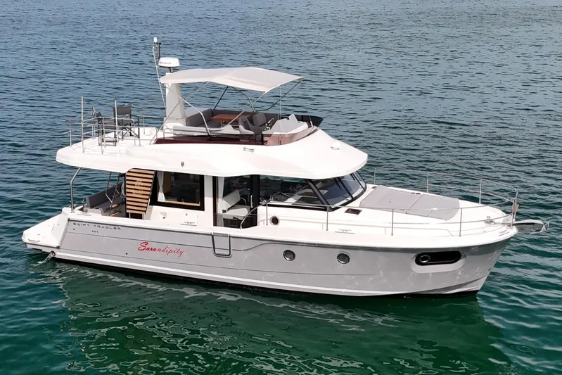 Sarandipity Yacht Photos Pics 2024 Beneteau Swift Trawler 41 Fly cruising on calm blue waters.
