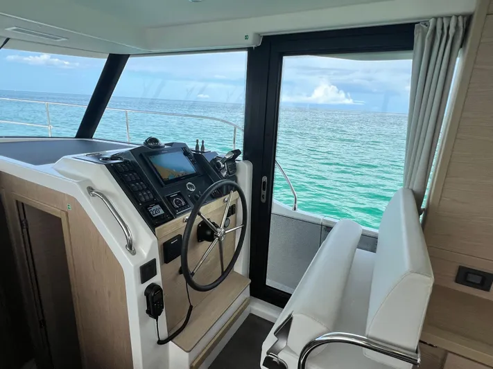 Sarandipity Yacht Photos Pics 2024 Beneteau Swift Trawler 41 Fly helm with ocean view, featuring modern navigation controls.