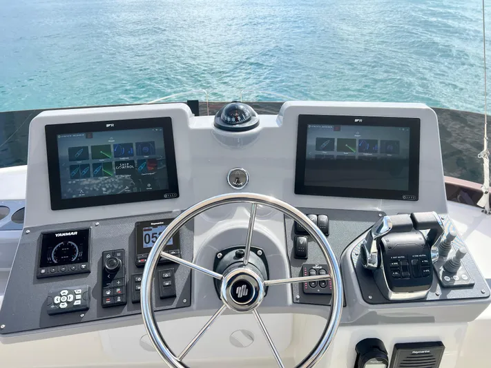 Sarandipity Yacht Photos Pics 2024 Beneteau Swift Trawler 41 Fly helm with dual screens and controls, overlooking water.