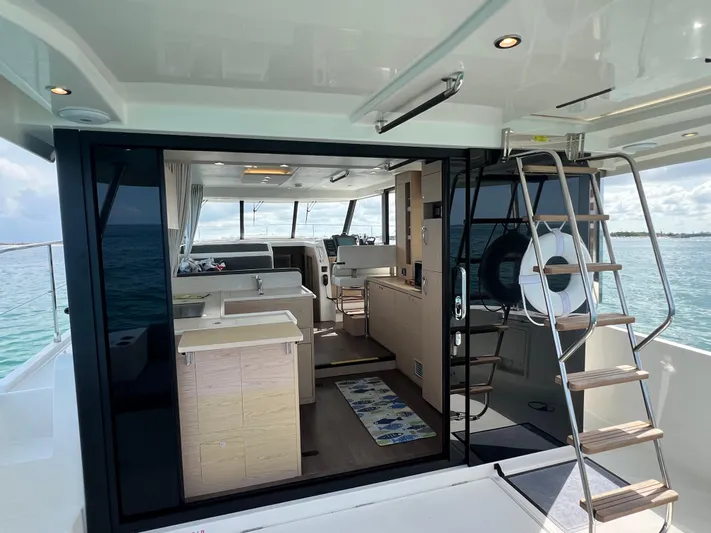 Sarandipity Yacht Photos Pics 2024 Beneteau Swift Trawler 41 Fly interior with ocean view, featuring modern kitchen and seating area.
