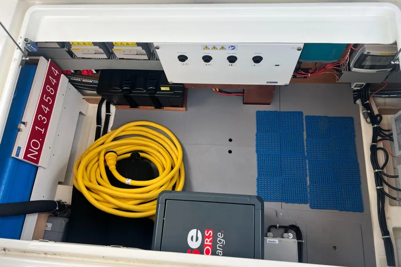 Sarandipity Yacht Photos Pics Engine room of 2024 Beneteau Swift Trawler 41 Fly with equipment and yellow hose.