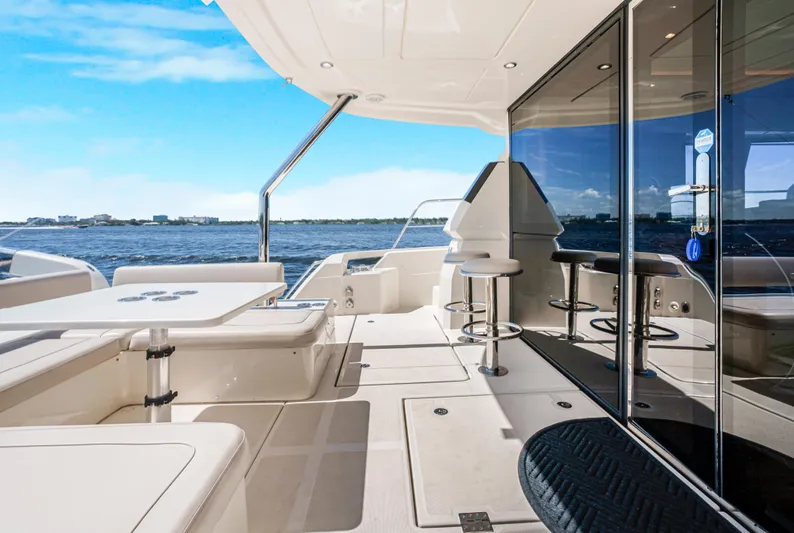 Ryan's Inheritance Yacht Photos Pics Aquila 44 Yacht 2017 deck with seating, table, and ocean view.