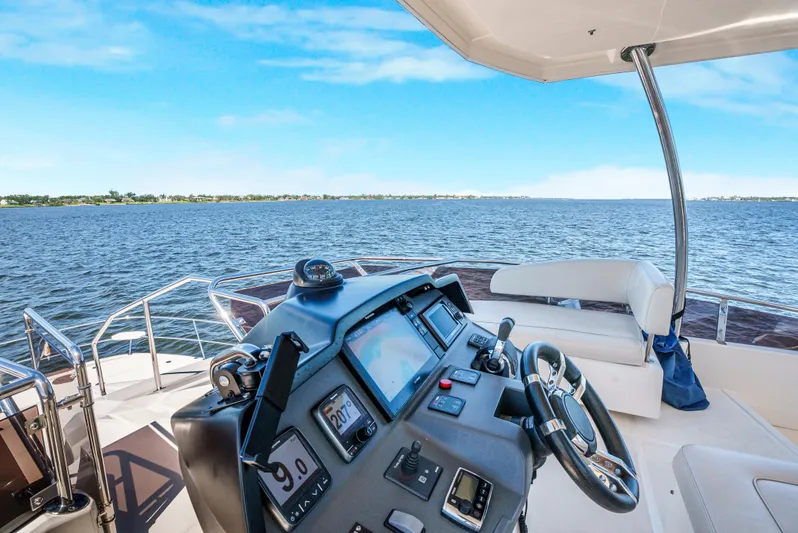 Ryan's Inheritance Yacht Photos Pics Helm of 2017 Aquila 44 Yacht with ocean view and clear blue sky.