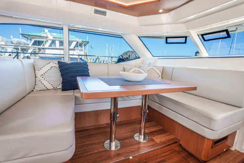 Ryan's Inheritance Yacht Photos Pics Luxurious interior of 2017 Aquila 44 Yacht with elegant seating and table.