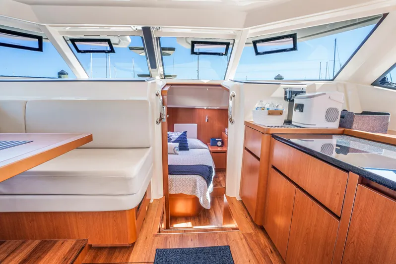 Ryan's Inheritance Yacht Photos Pics Interior of 2017 Aquila 44 Yacht featuring dining area, kitchenette, and cozy cabin.