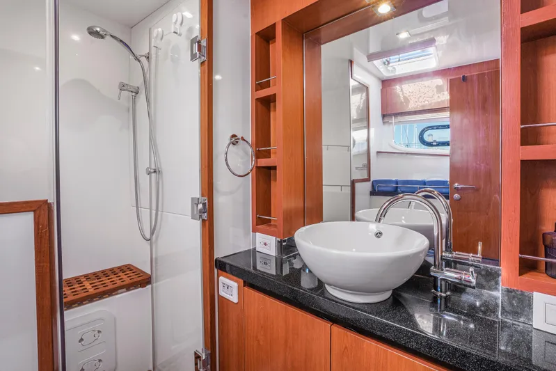 Ryan's Inheritance Yacht Photos Pics Luxurious bathroom in 2017 Aquila 44 Yacht with modern sink and shower.