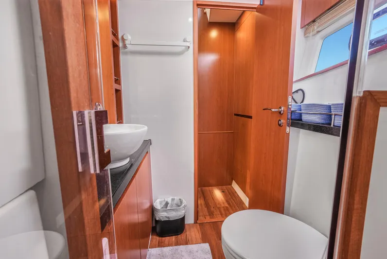 Ryan's Inheritance Yacht Photos Pics Luxurious bathroom interior of 2017 Aquila 44 Yacht with modern fixtures and wooden accents.