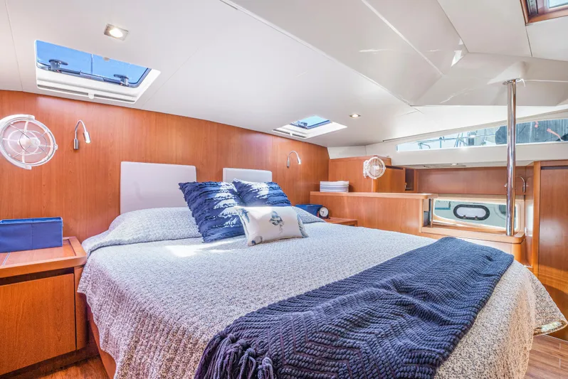 Ryan's Inheritance Yacht Photos Pics Luxurious cabin interior of 2017 Aquila 44 Yacht with cozy bed and elegant wood finish.