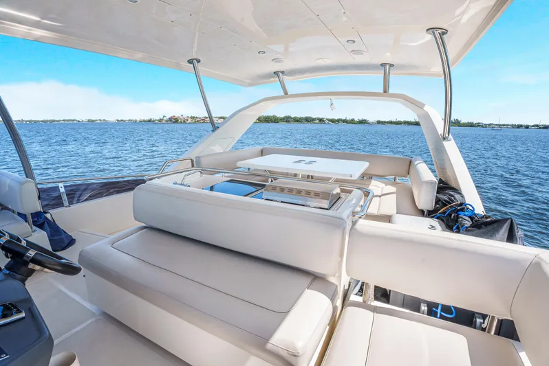 Ryan's Inheritance Yacht Photos Pics Luxurious 2017 Aquila 44 Yacht interior with seating, overlooking serene blue waters.