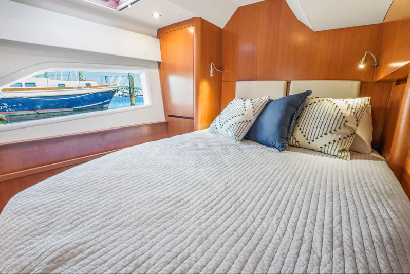 Ryan's Inheritance Yacht Photos Pics Luxurious cabin interior of 2017 Aquila 44 Yacht with cozy bedding and scenic window view.