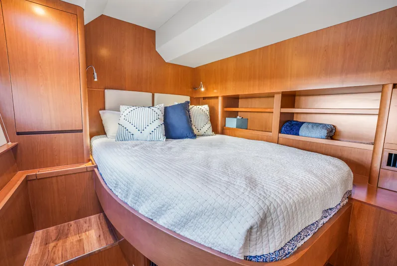 Ryan's Inheritance Yacht Photos Pics Luxurious bedroom interior of 2017 Aquila 44 Yacht with cozy bedding and wooden accents.