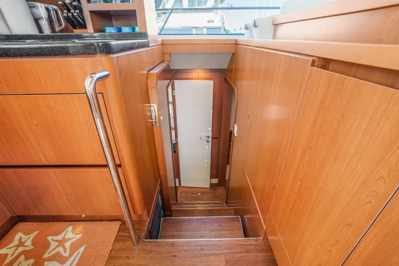 Ryan's Inheritance Yacht Photos Pics Stairway inside 2017 Aquila 44 Yacht with wooden paneling and modern design.