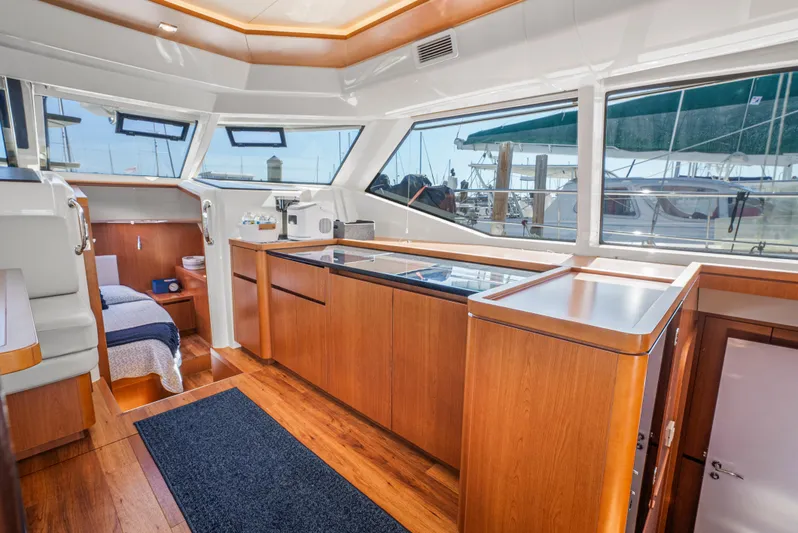 Ryan's Inheritance Yacht Photos Pics Luxurious interior of 2017 Aquila 44 Yacht with modern wood finishes and large windows.